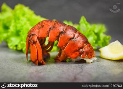 Lobster tail on dark plate background / red lobster food on dining table