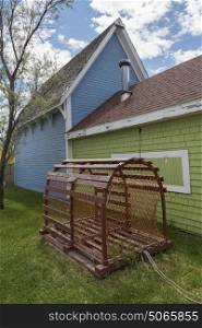 Lobster trap by houses in town, Pictou, Nova Scotia, Canada