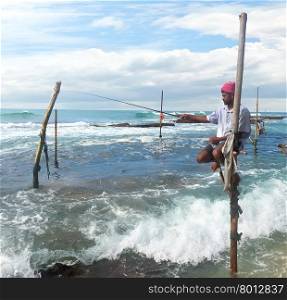 Local fisherman on stick in indian ocean, Sri lanka