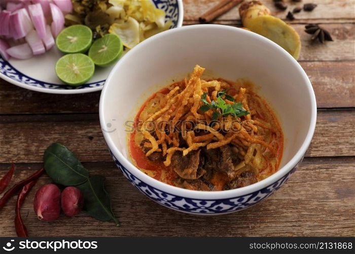 Local northern Thai food Egg noodle curry with beef on wood background