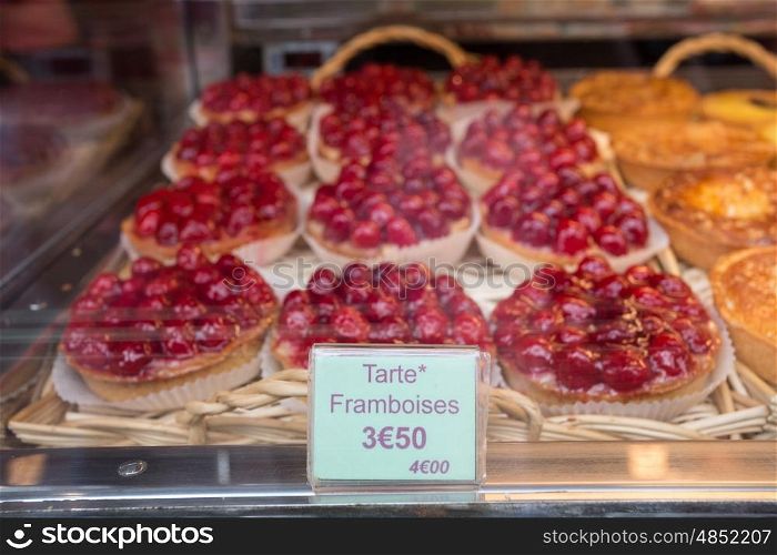 Local patiserie in Paris showing the typical french pastries: raspberry pies