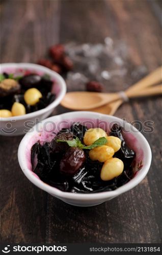 Local Thai dessert glass jelly isolated in wood background