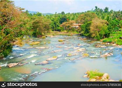 Locals swimming in mountain river in Sri Lanka