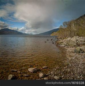 Loch Ness coastline in Highlands, Scotland. April midday.