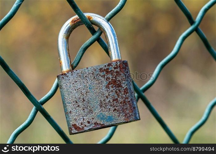 Lock as a symbol of love locked on the mesh