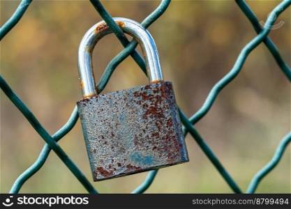 Lock as a symbol of love locked on the mesh