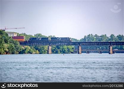 locomotive train bridge with train crossing lake