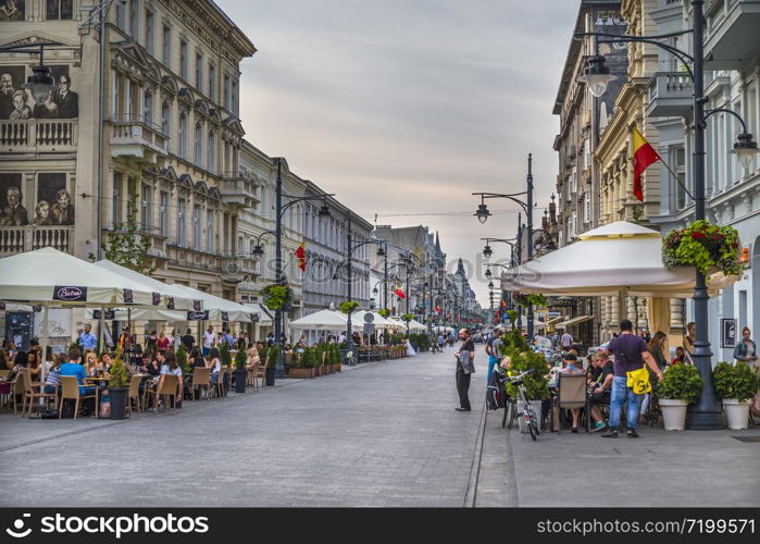 LODZ. POLAND - JULY 28, 2016 : Cafes and restaurants on Piotrkowska street in the evening. Poland