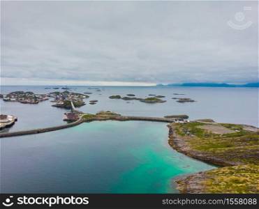 Lofoten landscape with road and bridge connecting the islands over the sea. Henningsvaer village Austvagoya island, Norway, overcast weather.. Aerial view. Lofoten islands landscape, Norway