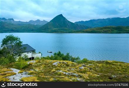 Lofoten summer cloudy view (Norway) with house on coast.