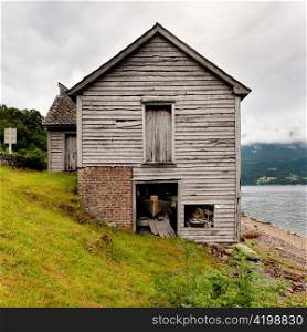Log cabin at the riverside, Hardangervidda, Hardanger, Norway