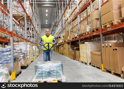 logistic business, loading and shipment concept - warehouse worker carrying loader with goods. warehouse worker carrying loader with goods. warehouse worker carrying loader with goods