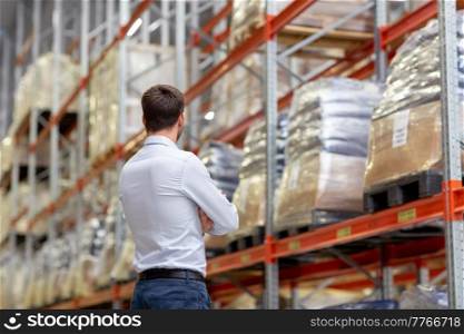 logistic business, shipment and people concept - businessman at warehouse. businessman at warehouse