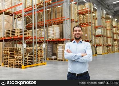 logistic business, shipment and people concept - happy businessman at warehouse. happy businessman at warehouse. happy businessman at warehouse
