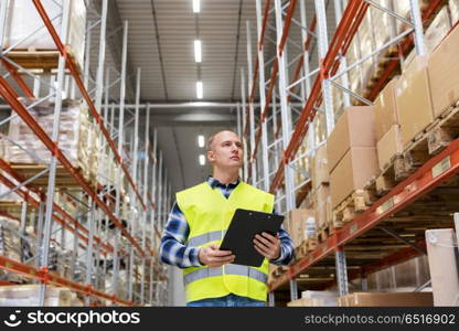 logistic business, shipment and people concept - male worker or supervisor with clipboard in reflective safety vest at warehouse. warehouse worker with clipboard in safety vest. warehouse worker with clipboard in safety vest