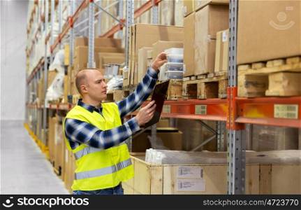 logistic business, shipment and people concept - male worker with clipboard and plastic box in reflective safety vest at warehouse. warehouse worker with clipboard and plastic box. warehouse worker with clipboard and plastic box