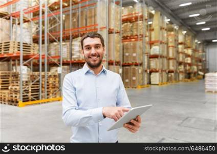 logistic business, technology and shipment concept - happy businessman with tablet pc computer checking goods at warehouse. happy businessman with tablet pc at warehouse. happy businessman with tablet pc at warehouse