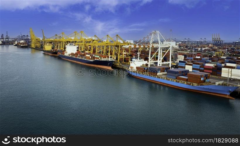 Logistic container ship from sea port warehouse with working crane bridge for delivery containers shipment. for transport or import export to global logistics concept. blue sky background
