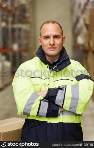 logistic, delivery, shipment, people and export concept - happy man or manual worker in coveralls with boxes at warehouse