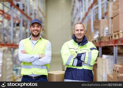 logistic, delivery, shipment, people and export concept - men or manual workers with boxes at warehouse