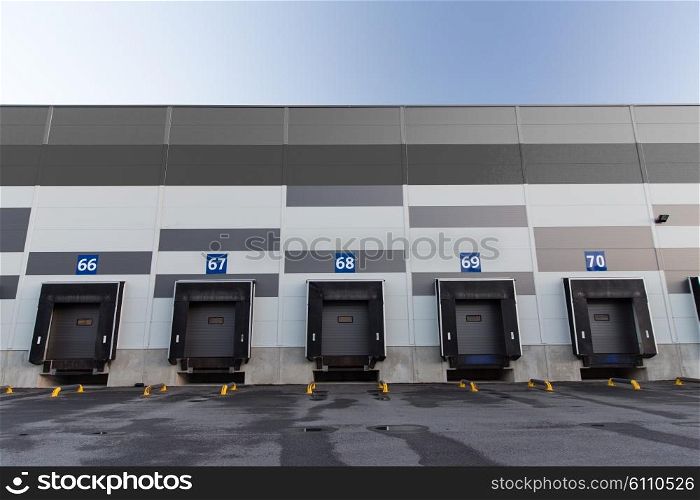 logistic, storage and shipment concept - warehouse gates