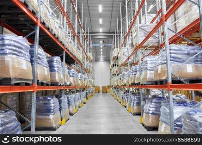 logistic, storage, shipment and industry concept - cargo storing at warehouse shelves. cargo storing at warehouse shelves