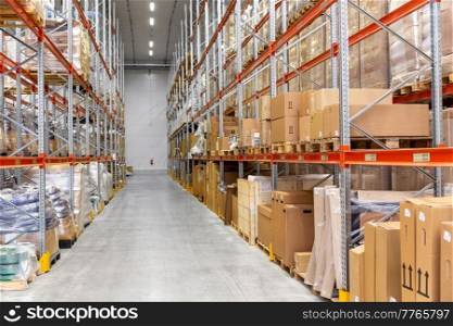 logistic, storage, shipment and industry concept - cargo storing at warehouse shelves. cargo storing at warehouse shelves