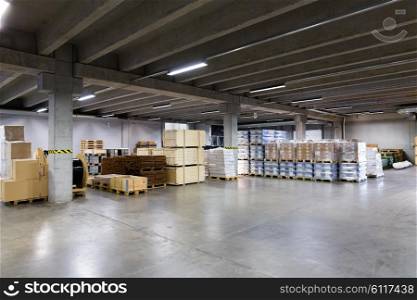 logistic, storage, shipment, industry and manufacturing concept - cargo boxes storing at warehouse
