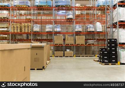 logistic, storage, shipment, industry and manufacturing concept - cargo boxes storing at warehouse shelves. cargo boxes storing at warehouse shelves
