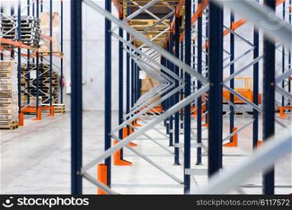 logistic, storage, shipment, industry and manufacturing concept - warehouse shelves or constructions with cargo