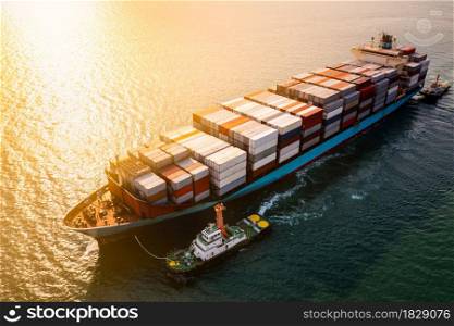 Logistics and transportation of International Container Cargo ship in the ocean and over the sunset background aerial view from drone