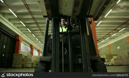 Logistics business and shipping facility with manual worker operating forklift to move boxes and parcels, man at work in warehouse, worker in industry. 5of19