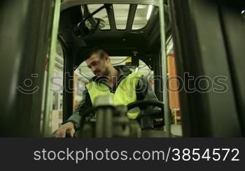Logistics business and shipping facility with manual worker operating forklift to move boxes and parcels, man at work in warehouse, worker in industry. 7of19
