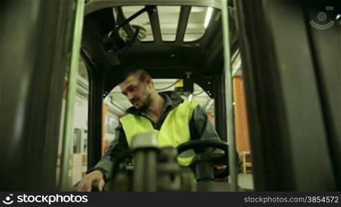 Logistics business and shipping facility with manual worker operating forklift to move boxes and parcels, man at work in warehouse, worker in industry. 7of19