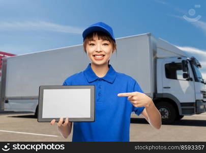 logistics, shipping and job concept - happy smiling delivery woman in blue uniform with tablet pc computer over truck background. smiling delivery woman with tablet pc over truck