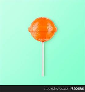 Lollipop mandarin isolated on mint background. Creative candy idea. Lollipop mandarin