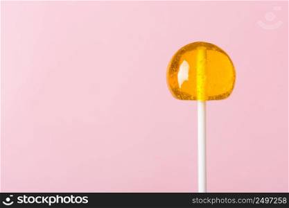 Lollipop on pink pastel background with copy space