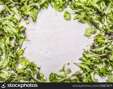 Lollo rosso lettuce fresh laid out frame on wooden rustic background top view close up place for text,frame