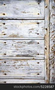 lombardy arsago seprio abstract rusty brass brown knocker in a door curch closed wood italy cross