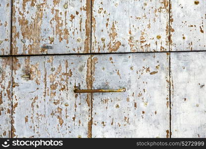 lombardy arsago seprio abstract rusty brass brown knocker in a door curch closed wood italy cross