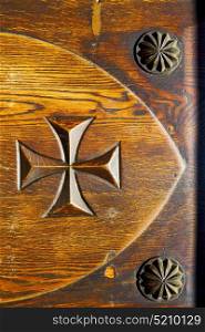 lombardy castellanza blur abstract rusty brass brown knocker in a door curch closed wood italy cross