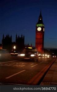 London circa 2009.Big Ben at night with taxis passing by