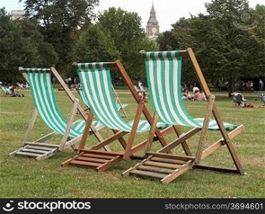 London circa 2009.Three deck chairs lined up in St.James&acute;s Park with Big Ben in background