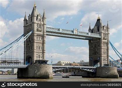 London circa 2009.Tower Bridge with a London tour bus viewed from The Thames river