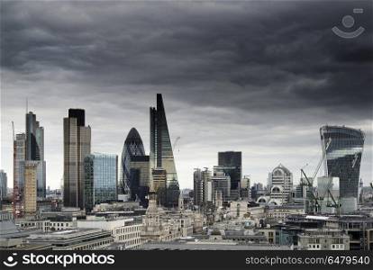 London cityscape skyline with iconic landmark buildings in The C. Places. London cityscape skyline with iconic landmark buildings in The City with dramatic stormy sky