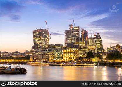 London downtown cityscape skylines building with River Thames at sunset dusk in London UK
