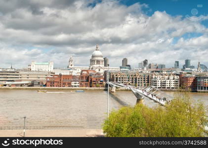 LONDON - May 4: urban landscape with St. Paul&rsquo;s Cathedral and Millennium Bridge, officially known as the London Millennium Footbridge, on May 4, 2013 in London, England opening in June 2000