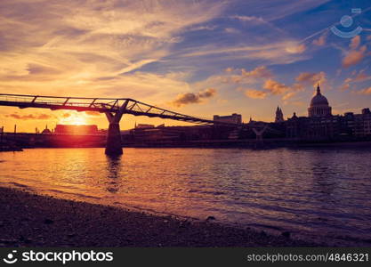 London Millennium bridge sunset skyline in UK at dusk