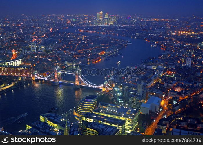 London rooftop view panorama at sunset with urban architectures and The Tower Bridge with Thames River at night