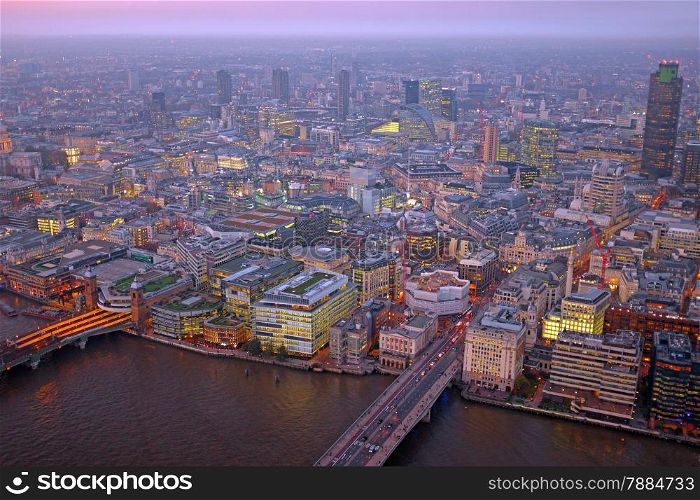 London rooftop view panorama at sunset with urban architectures with Thames River at night